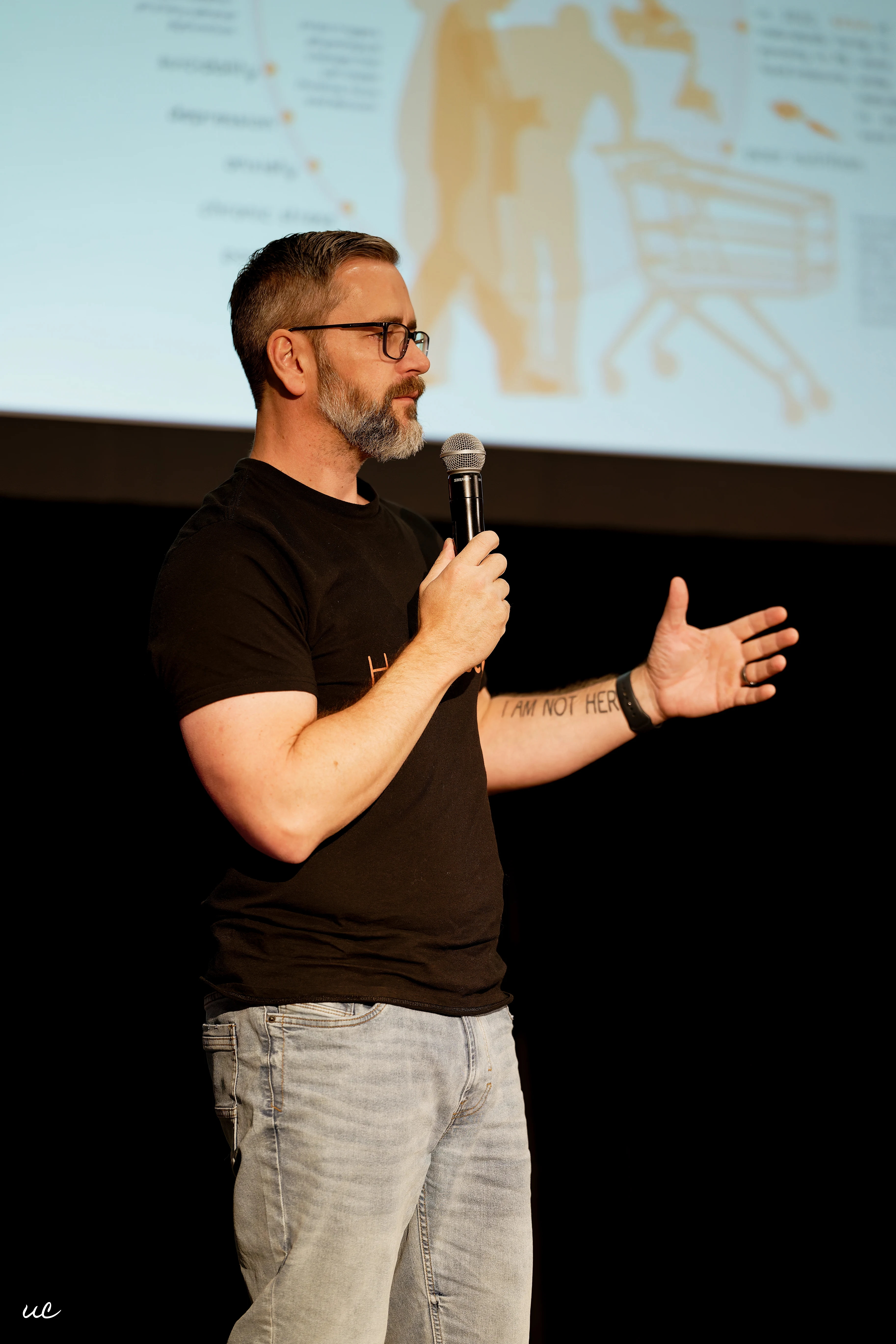 A HeadCase speaker holding a microphone during a session